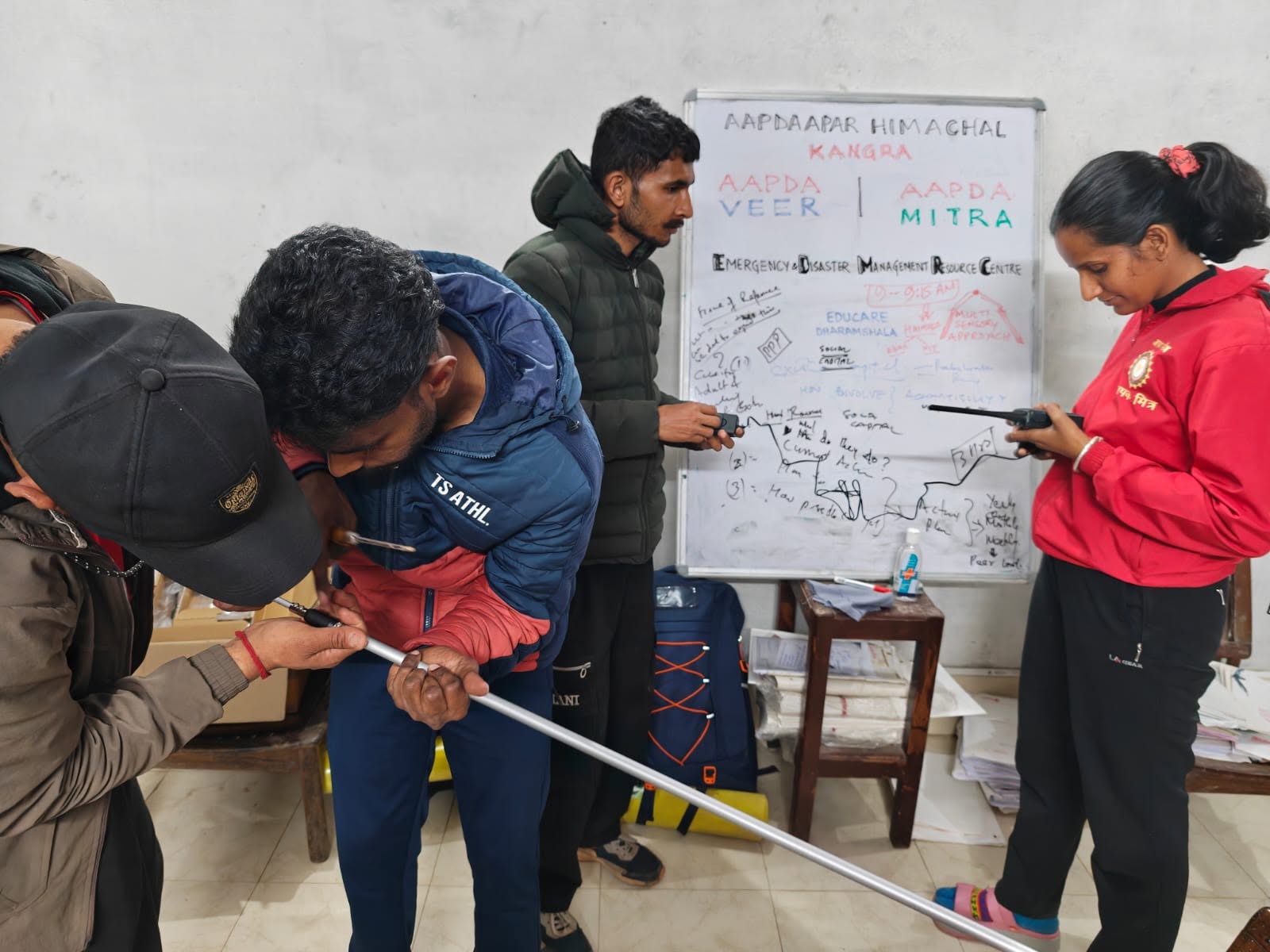 Volunteers configuring tools during a disaster-management training exercise.