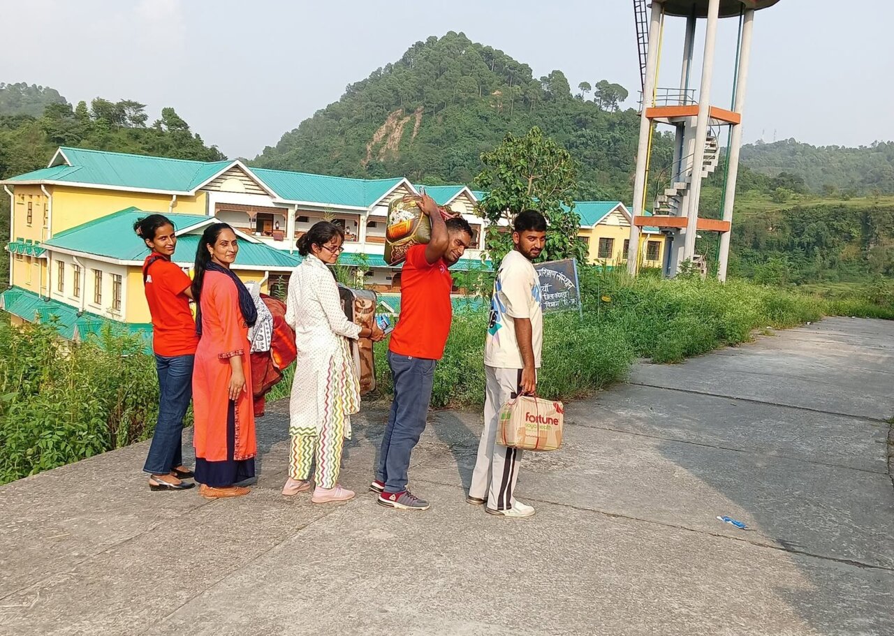 Volunteers and community members doing project work outdoors in Ambara, Himachal Pradesh.