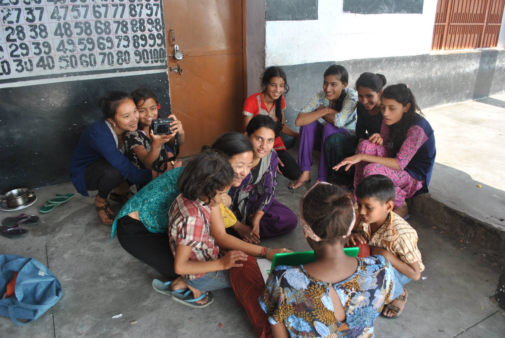 Girls club meeting in a school courtyard.