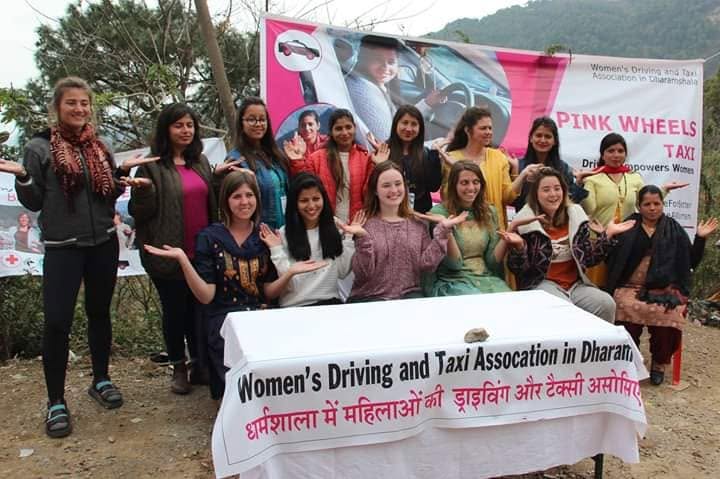 Pink Wheels Taxi Initiative group photo at an event.