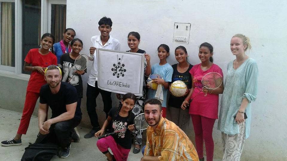 Members of a sports club holding an EduCARE India poster.