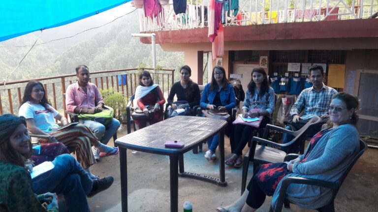 Our team having a group discussion outdoors in Naddi, Himachal Pradesh.