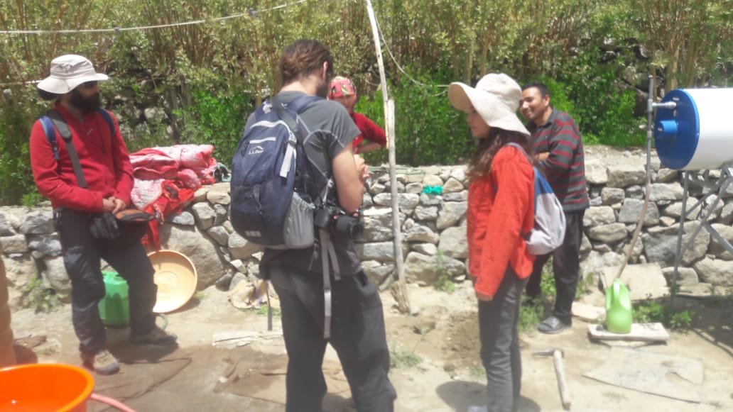 Group of volunteers discussing something whilst standing outside.