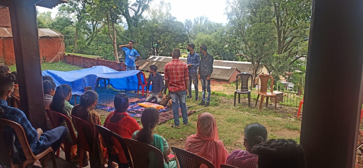 Volunteers attending a training session outdoors.